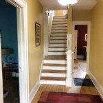 Stairs going up on the left, hallway on the right