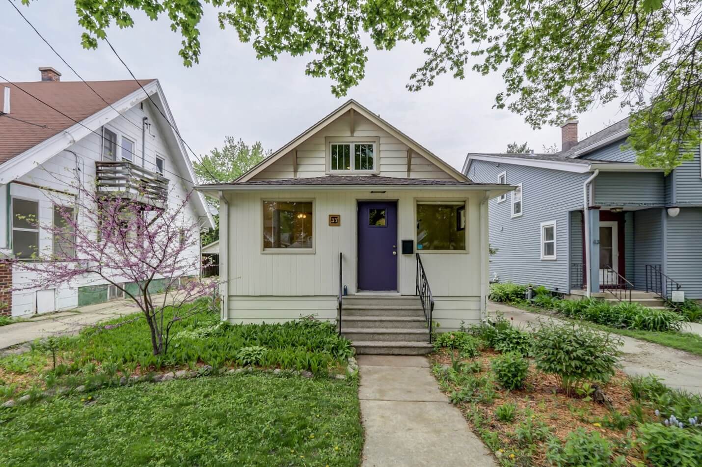 white single story house with purple door